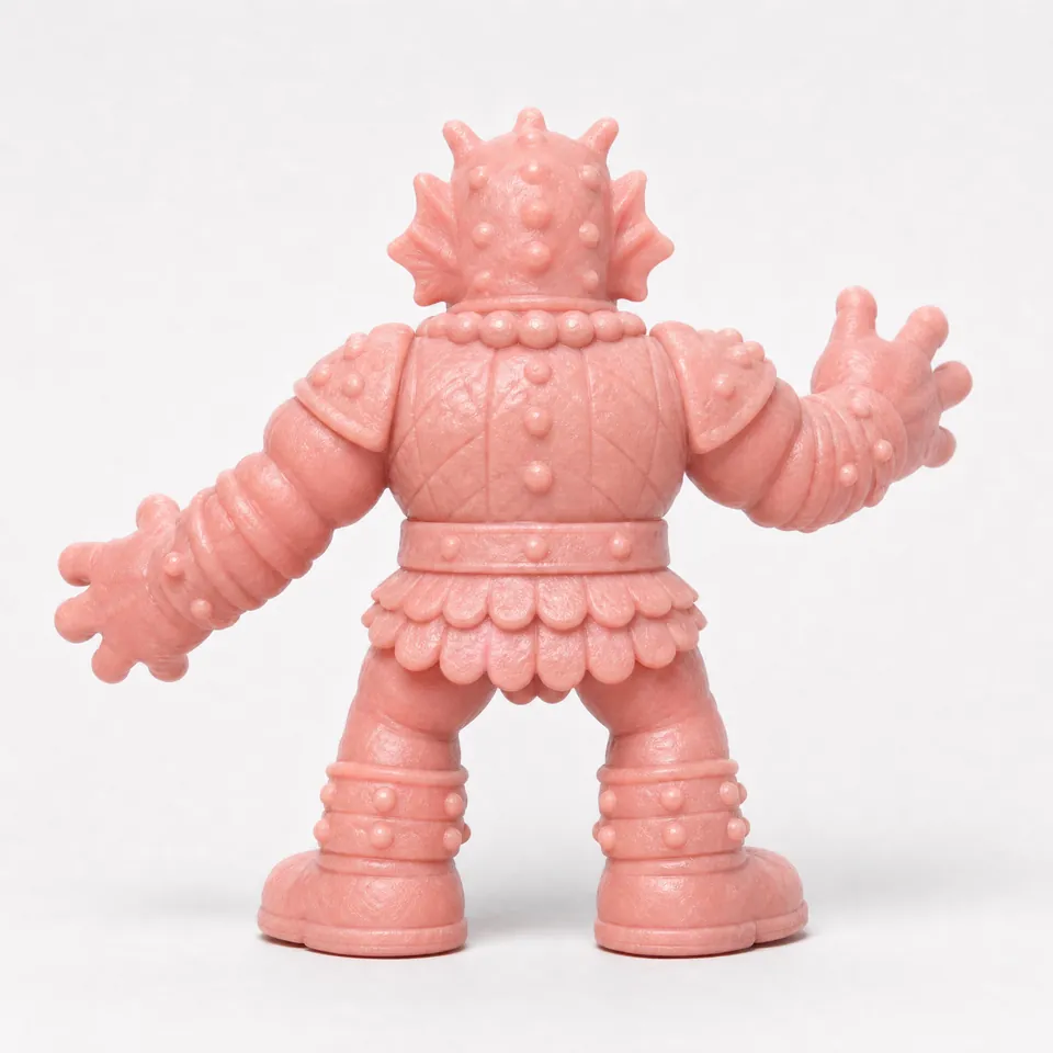 Back reference of the cyclops warrior, showing the studded head, quilted back armor, belt and scalloped skirt.