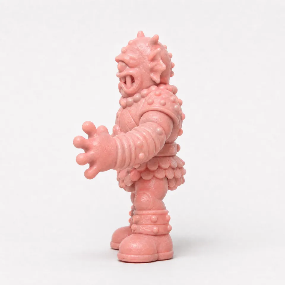 Side reference of the cyclops warrior, showing the open mouth in profile, a banded forearm reaching forward and chunky boots.